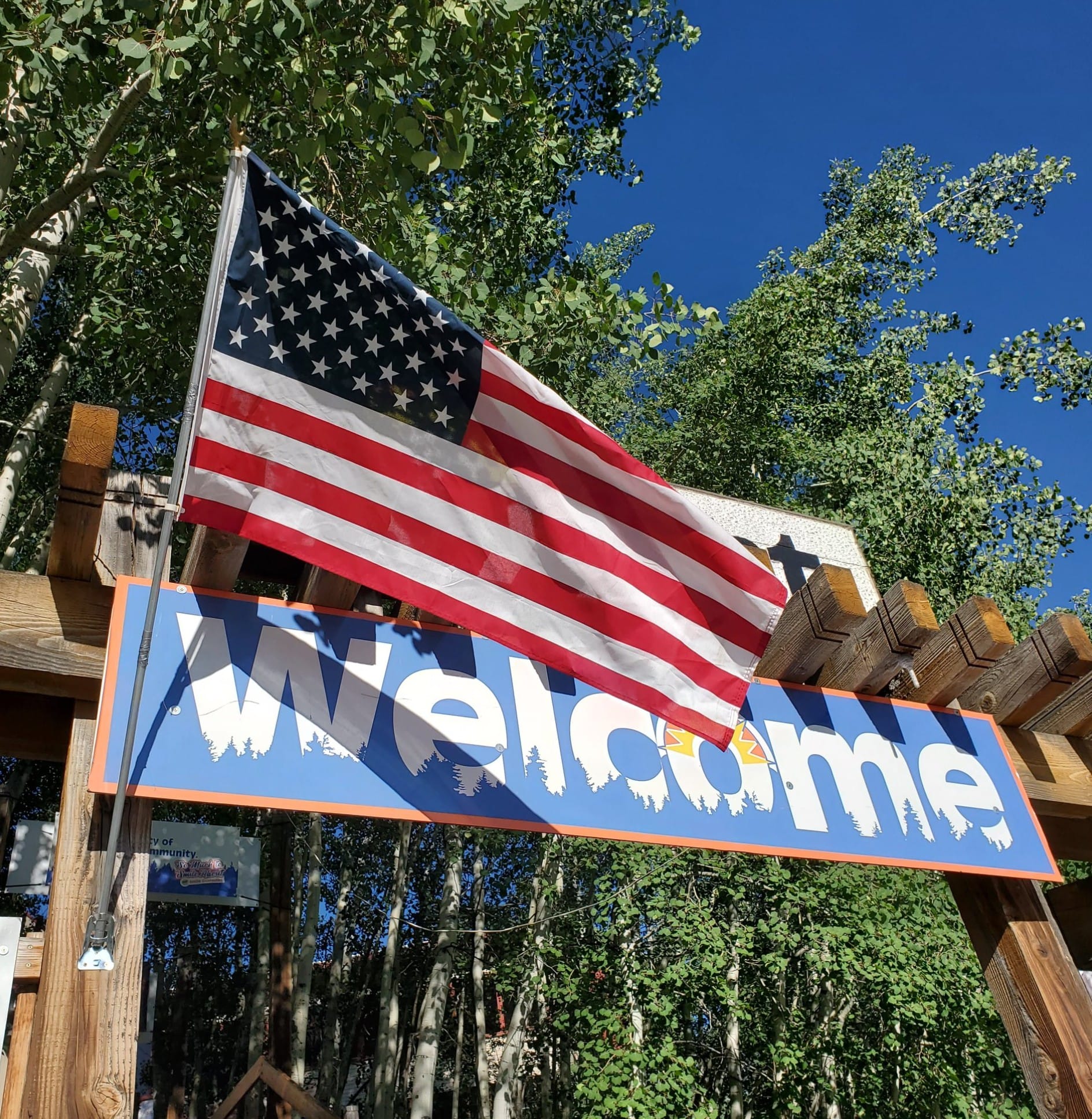 Welcome sign and American Flag